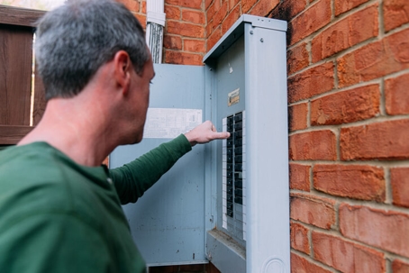 man checking electrical panel